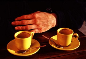 two coffee cups and one hand